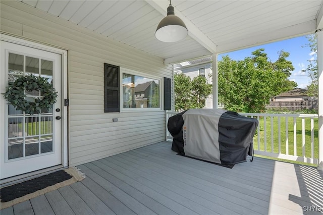 deck featuring grilling area and a yard