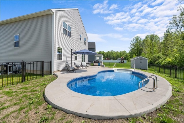 view of swimming pool featuring a patio area, a storage unit, and an outdoor structure
