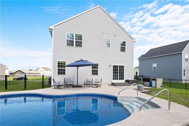view of swimming pool featuring a patio area and fence