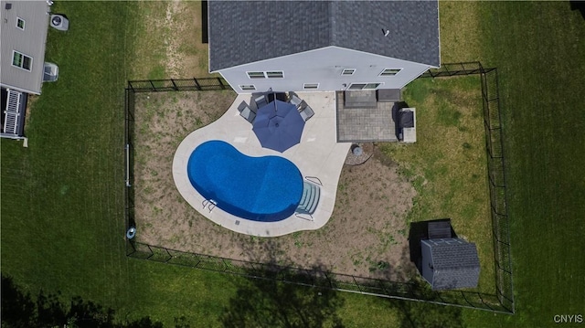 aerial view of property and surrounding area featuring a pool area
