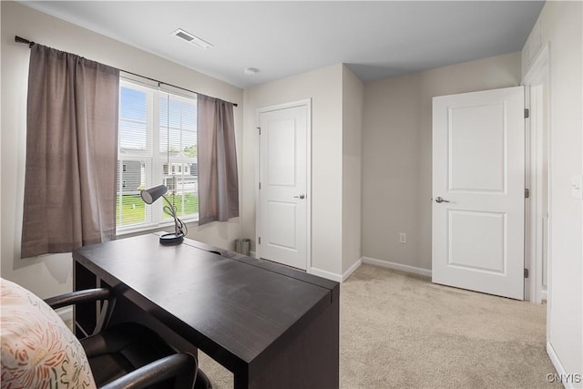 office area with light carpet and baseboards