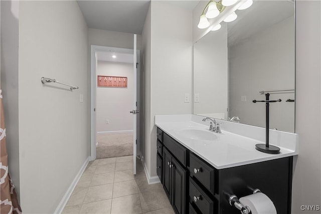 bathroom featuring vanity, tile patterned flooring, and baseboards