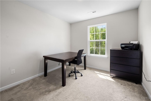 carpeted home office with baseboards