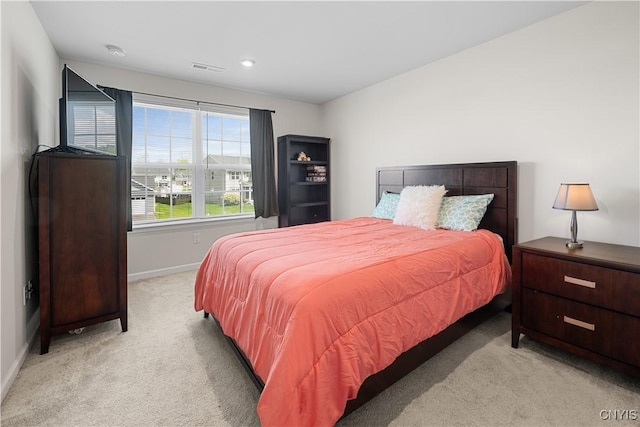 bedroom featuring light carpet, baseboards, and recessed lighting