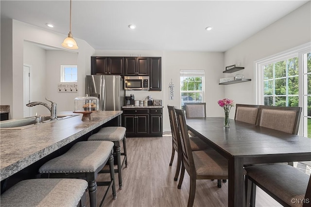 dining area featuring light wood-type flooring and recessed lighting