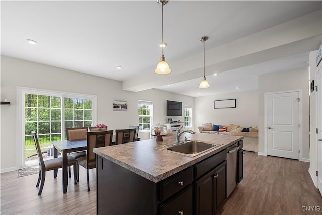 kitchen featuring a sink, stainless steel dishwasher, wood finished floors, baseboards, and recessed lighting