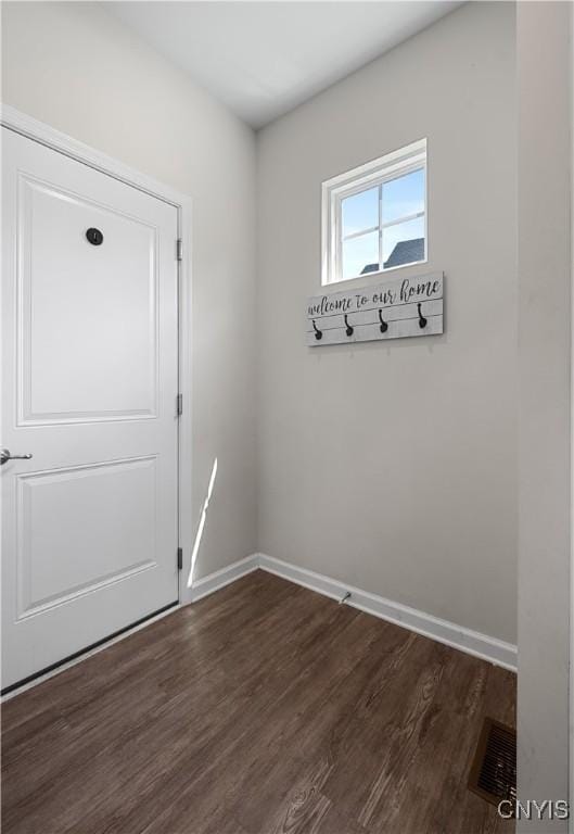 entryway featuring dark wood finished floors and baseboards