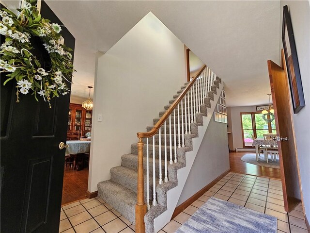 4862 Cross St, Campbell, NY 14821 - stairs featuring tile patterned floors, baseboards, and a chandelier
