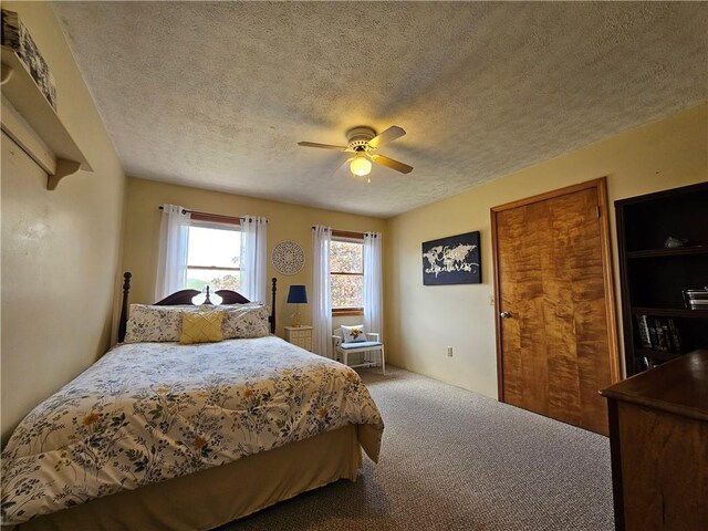 4862 Cross St, Campbell, NY 14821 - carpeted bedroom with a textured ceiling and ceiling fan