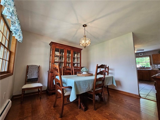 4862 Cross St, Campbell, NY 14821 - dining room with baseboard heating, a chandelier, hardwood / wood-style floors, and baseboards