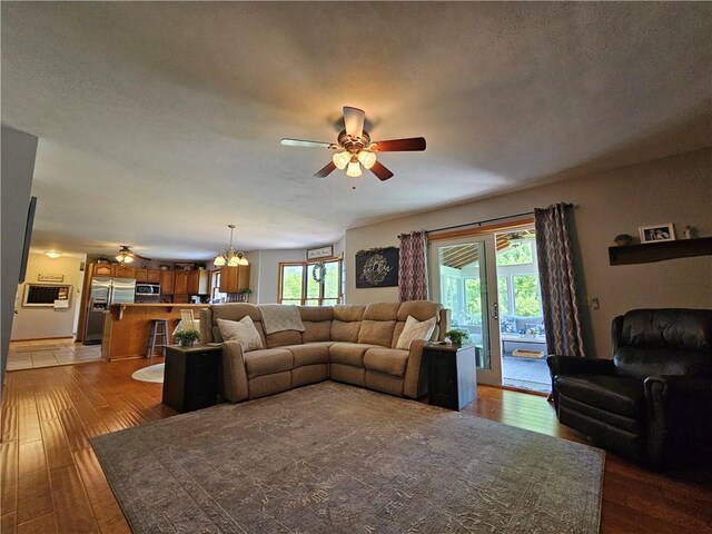 4862 Cross St, Campbell, NY 14821 - living room with a ceiling fan, light wood-style flooring, and a chandelier