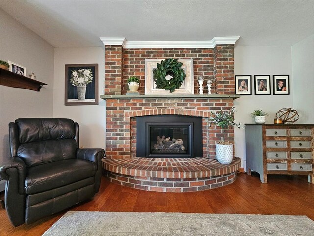 4862 Cross St, Campbell, NY 14821 - living area featuring wood finished floors and a brick fireplace