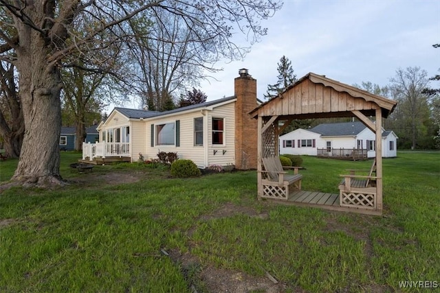 9910 Shorecliff Rd, Evans, NY 14006 - back of property with a gazebo, a deck, a chimney, and a yard