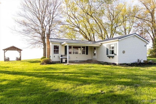 9910 Shorecliff Rd, Evans, NY 14006 - view of front of house featuring a front yard, a chimney, and metal roof