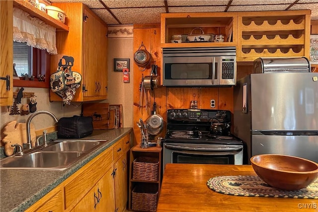 123 Mohawk Dr W, Webb, NY 13420 - kitchen featuring stainless steel appliances, a sink, brown cabinetry, dark countertops, and open shelves