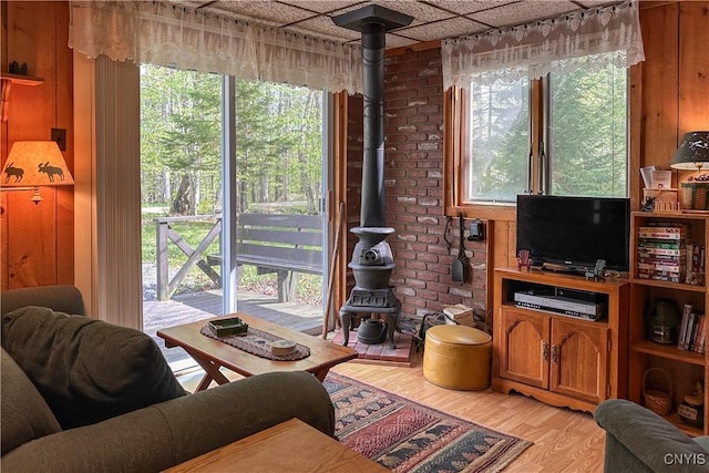 123 Mohawk Dr W, Webb, NY 13420 - living room with light wood-type flooring, a wood stove, and wooden walls