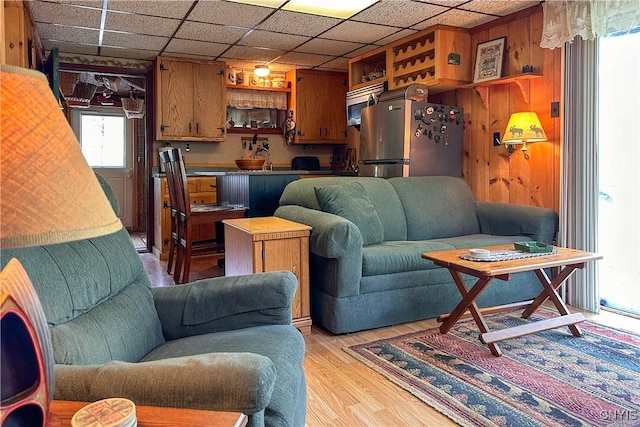 123 Mohawk Dr W, Webb, NY 13420 - living area with light wood-style flooring and a drop ceiling