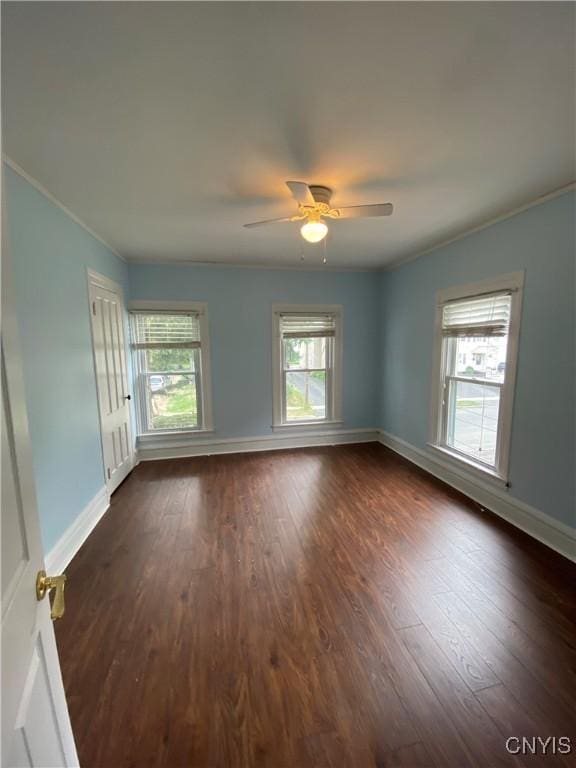 533 Mundy St, Watertown-City, NY 13601 - empty room featuring baseboards, dark wood-style floors, ornamental molding, and ceiling fan
