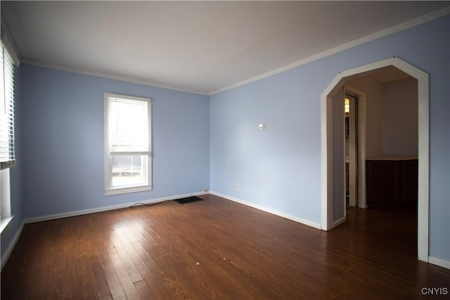 533 Mundy St, Watertown-City, NY 13601 - empty room featuring arched walkways, dark wood-style flooring, baseboards, and crown molding