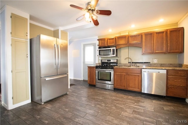 533 Mundy St, Watertown-City, NY 13601 - kitchen featuring appliances with stainless steel finishes, brown cabinets, dark wood finished floors, a ceiling fan, and ornamental molding