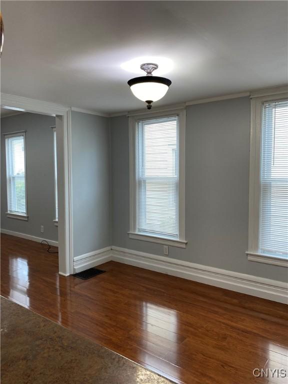 533 Mundy St, Watertown-City, NY 13601 - spare room with wood finished floors, baseboards, and crown molding