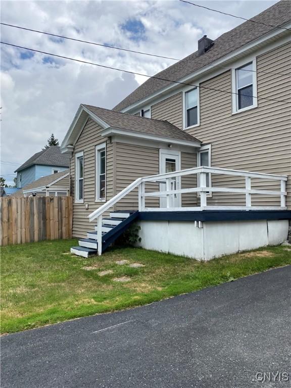 533 Mundy St, Watertown-City, NY 13601 - view of side of property with a shingled roof and a chimney