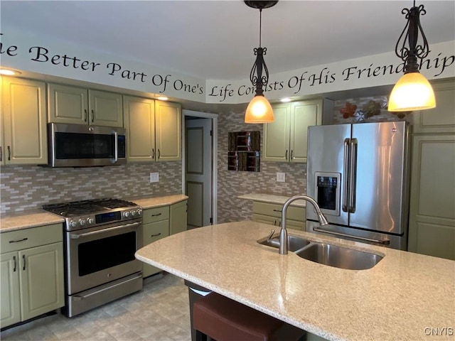 533 Mundy St, Watertown-City, NY 13601 - kitchen featuring stainless steel appliances, a sink, decorative backsplash, hanging light fixtures, and green cabinets