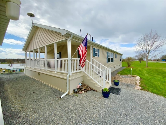 2570 Humphrey Rd, Cape Vincent, NY 13618 - view of front of property featuring covered porch, a front lawn, and crawl space
