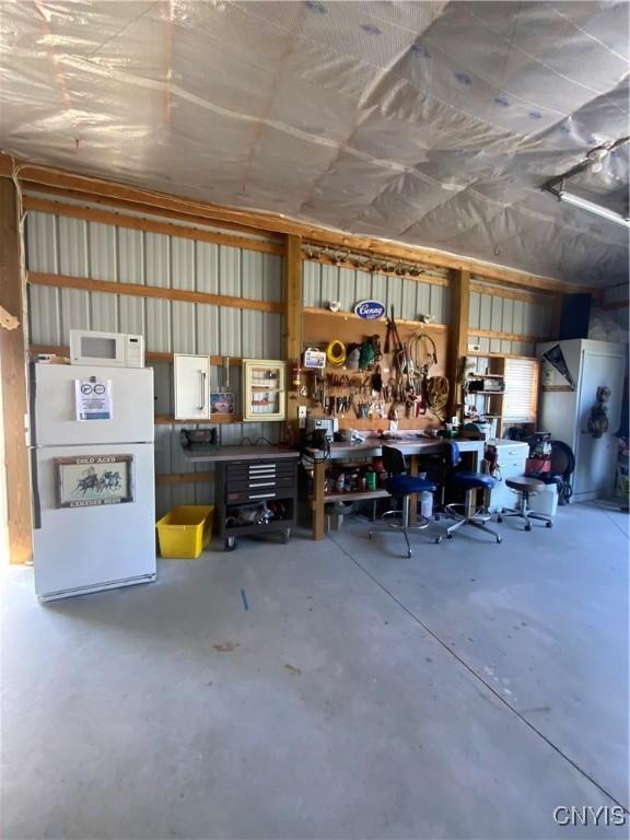 2570 Humphrey Rd, Cape Vincent, NY 13618 - garage featuring freestanding refrigerator and a workshop area