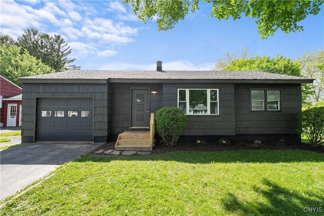 ranch-style house with a garage, a front yard, driveway, and a shingled roof