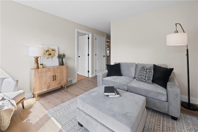 living area with wood finished floors and baseboards