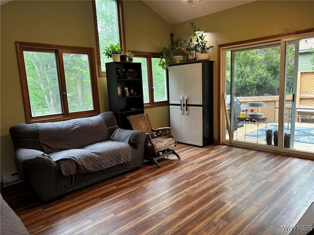 158 E Main St, Concord, NY 14141 - living area featuring lofted ceiling, wood finished floors, plenty of natural light, and baseboard heating