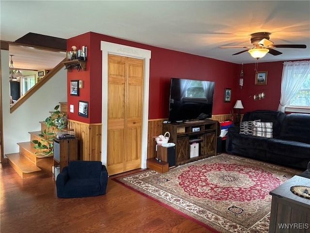 158 E Main St, Concord, NY 14141 - living area featuring a wainscoted wall, ceiling fan, wood finished floors, stairs, and wood walls