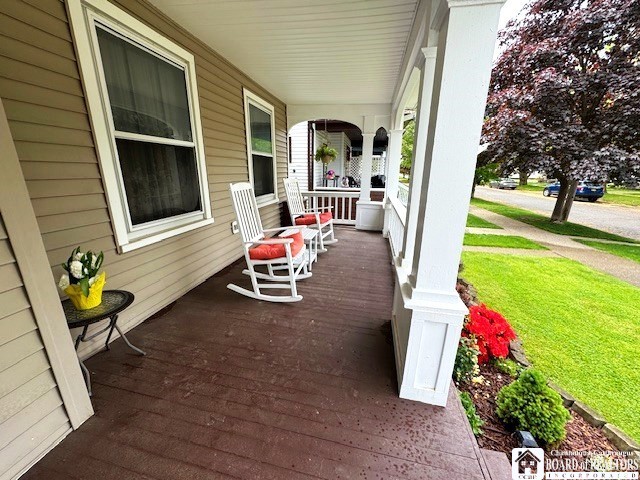 416 Robin St, Dunkirk-City, NY 14048 - wooden terrace with covered porch and a lawn