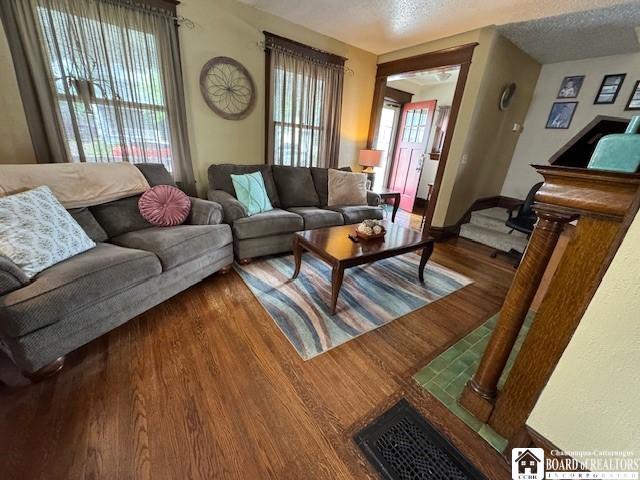 416 Robin St, Dunkirk-City, NY 14048 - living room featuring wood finished floors, baseboards, and a textured ceiling