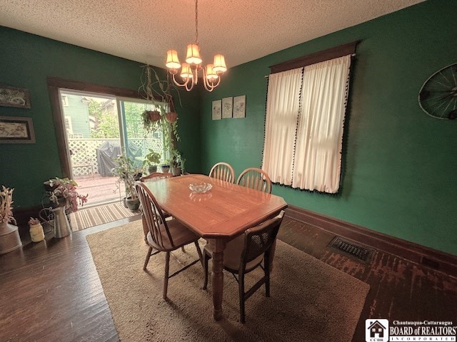 416 Robin St, Dunkirk-City, NY 14048 - dining space featuring a chandelier, a textured ceiling, and wood finished floors