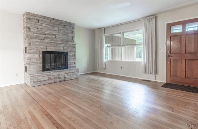 115 Stafford Dr, Rutland, NY 13612 - unfurnished living room featuring wood finished floors, a fireplace, and baseboards