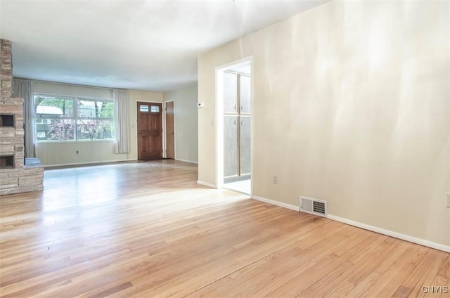 115 Stafford Dr, Rutland, NY 13612 - unfurnished living room with a fireplace, wood finished floors, and baseboards