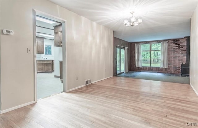 115 Stafford Dr, Rutland, NY 13612 - unfurnished living room with a chandelier, wood finished floors, baseboards, and a sink