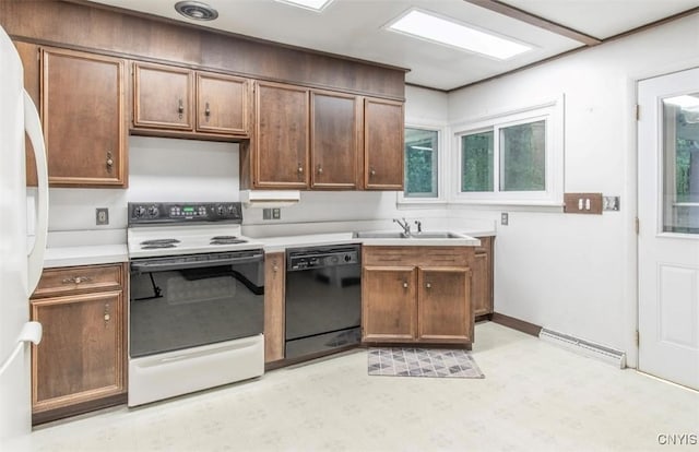 115 Stafford Dr, Rutland, NY 13612 - kitchen featuring white appliances, a sink, light countertops, light flooring, and a baseboard radiator