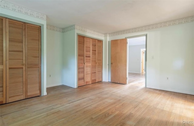 115 Stafford Dr, Rutland, NY 13612 - unfurnished bedroom with two closets, light wood finished floors, and baseboards