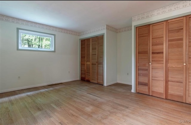 115 Stafford Dr, Rutland, NY 13612 - unfurnished bedroom featuring multiple closets, baseboards, and light wood-type flooring