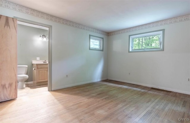 115 Stafford Dr, Rutland, NY 13612 - unfurnished bedroom featuring light wood finished floors, baseboards, and connected bathroom