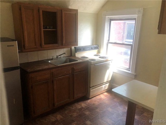515 9th St, Niagara Falls, NY 14301 - kitchen featuring electric range, a sink, freestanding refrigerator, healthy amount of natural light, and vaulted ceiling