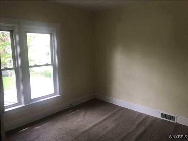 515 9th St, Niagara Falls, NY 14301 - unfurnished room featuring baseboards, dark carpet, and plenty of natural light