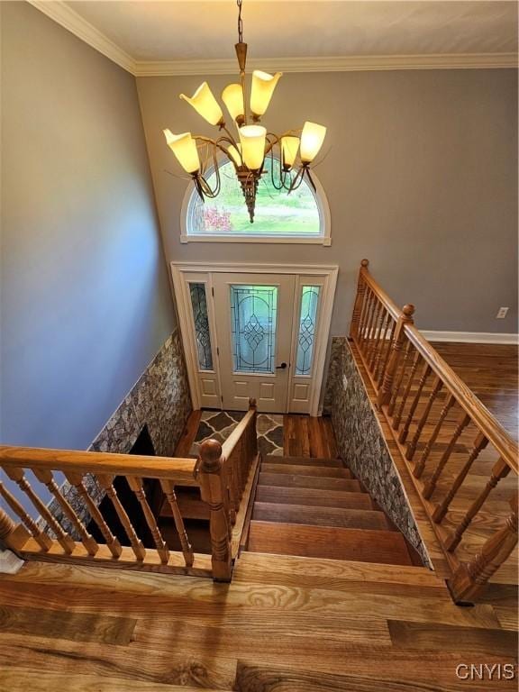 5813 Grace Rd, Deerfield, NY 13502 - stairs featuring a chandelier, wood finished floors, and ornamental molding