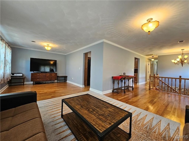 5813 Grace Rd, Deerfield, NY 13502 - living room with wood finished floors, a chandelier, baseboards, and crown molding