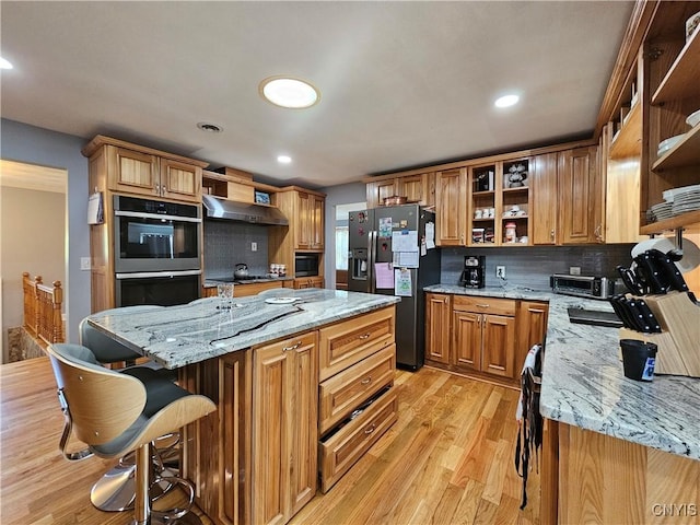 5813 Grace Rd, Deerfield, NY 13502 - kitchen with open shelves, stainless steel fridge, double oven, light wood finished floors, and a kitchen island