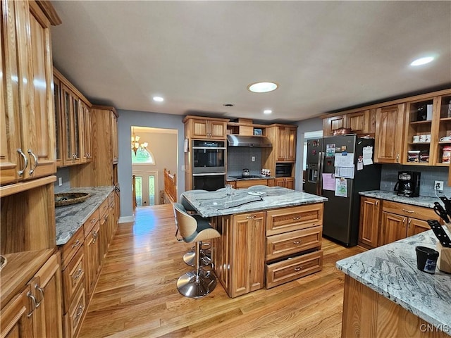 5813 Grace Rd, Deerfield, NY 13502 - kitchen with fridge with ice dispenser, light wood finished floors, open shelves, stainless steel double oven, and a center island