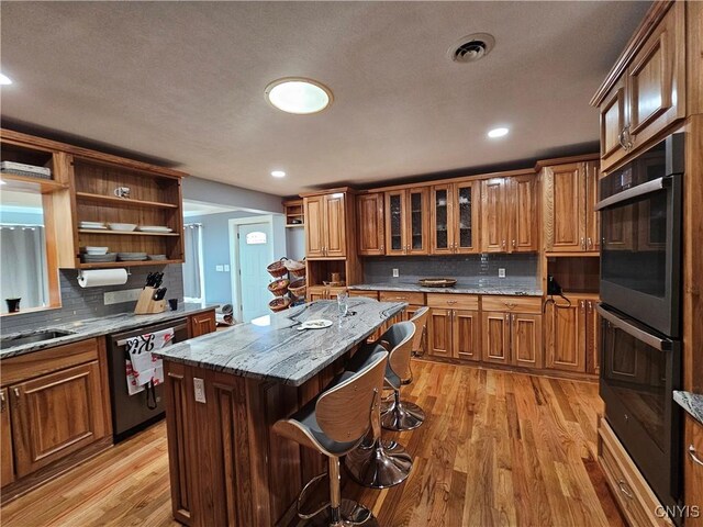 5813 Grace Rd, Deerfield, NY 13502 - kitchen with open shelves, dishwashing machine, light wood-type flooring, brown cabinetry, and recessed lighting